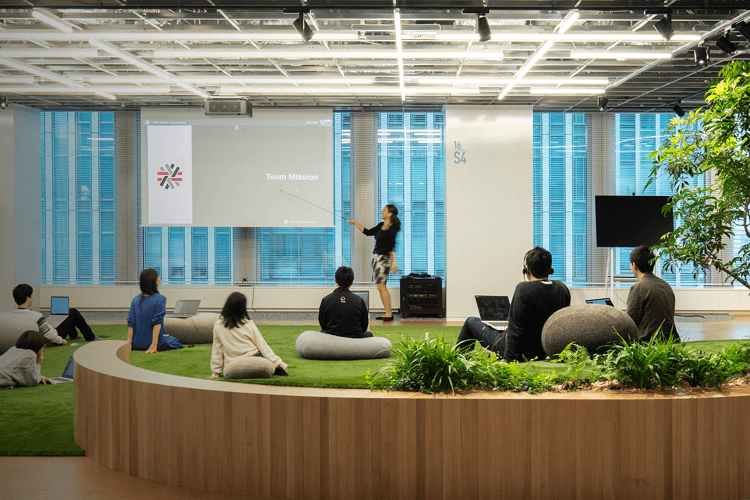 Employees gathered in open office space during team presentation and discussion